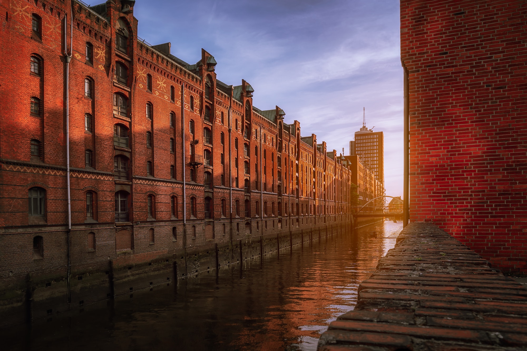 Speicherstadt warehouse district during sunset in Hamburg, Germany. Old brick buildings of Hafencity